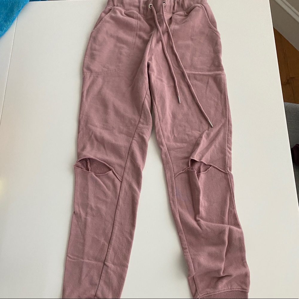Garage pink mauve sweats with rips in knee